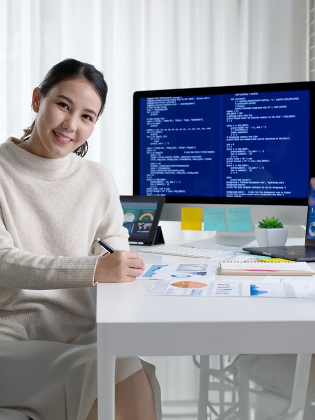 A female software engineer looking at the camera while coding laptop, concept of Google Nest job openings and recruitment in Feb 2025