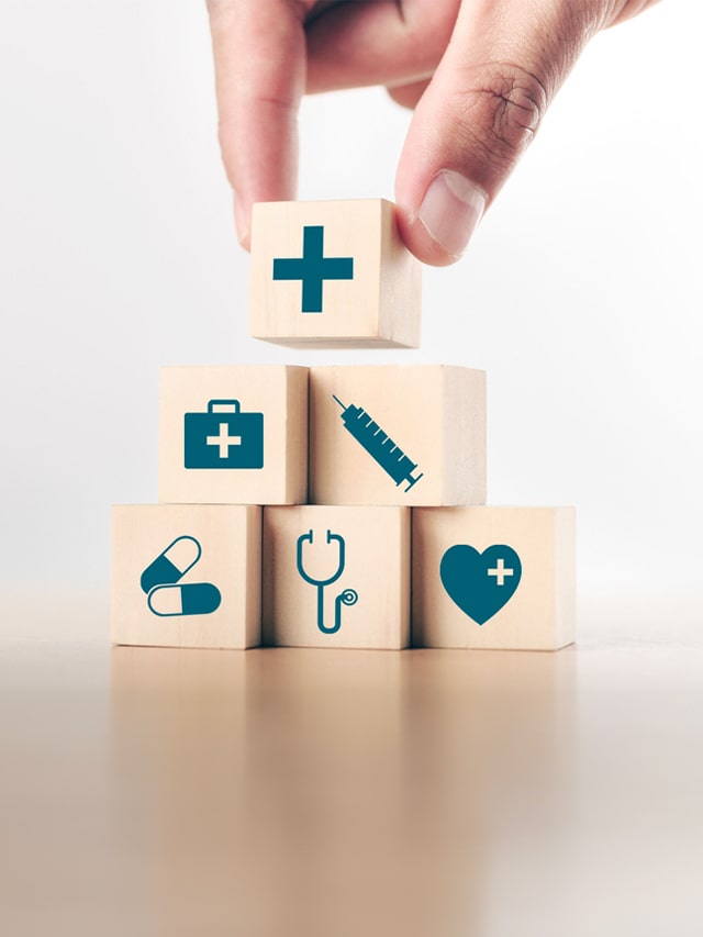 Hand arranging wood block stacking with the healthcare medical icon; concept of High-Paying Medical Jobs Without NEET in India