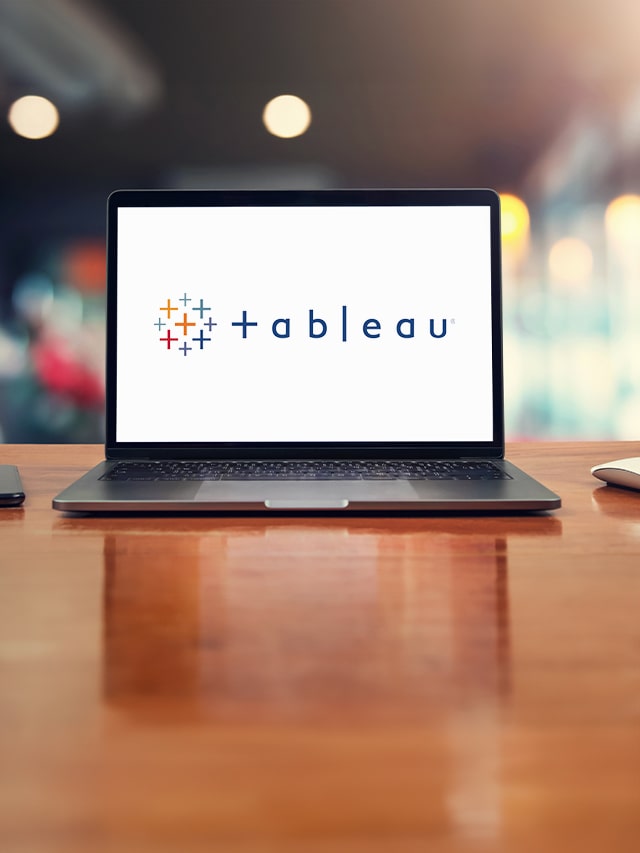 tableau written on a laptop with logo with white screen, put on a table; concept of top companies hiring Tableau Developer