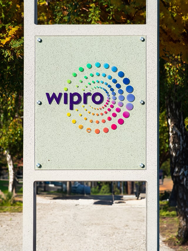 Wipro logo and sign at Indian corporation office comprises multi-coloured dots in four circles; concept of Most Asked WIPRO Interview Questions