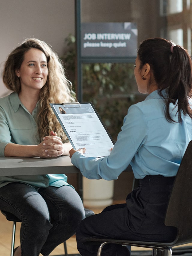 Woman presenting her resume at interview. Concept of How to Introduce Yourself in Job Interview?