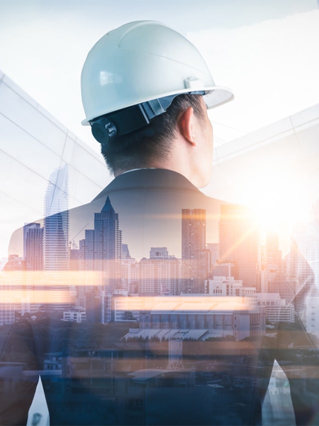 The double exposure image of the engineer standing back during sunrise overlay with cityscape image. Concept of hiring Network engineer, recruitment, career, network engineer jobs
