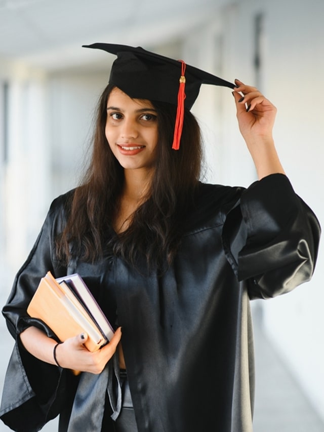 Happy Indian university student in graduation gown and cap holding diploma certificate.; concept of Launch Your Dream Career with Options After 12th Science (PCM)