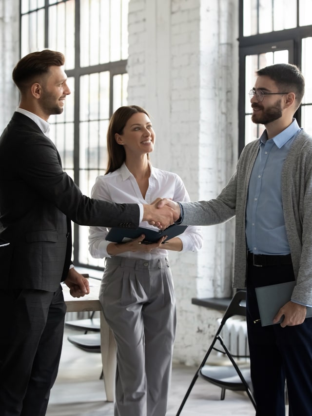 Happy male business partners shake hands get acquainted greeting in office, smiling businessmen handshake. Concept of How to Introduce Yourself in an Interview ?