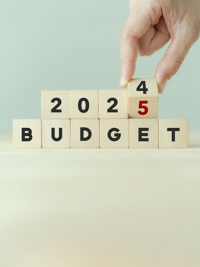 2025 Budget planning and allocation concept. Hand flips wooden cube and changes the inscription "BUDGET 2024" to "BUDGET 2025" with grey; concept of Union Budget 2024's internship schemes, youth empowerment and skill development, internship opportunities introduced in Union Budget 2024, fostering youth development and skill enhancement.