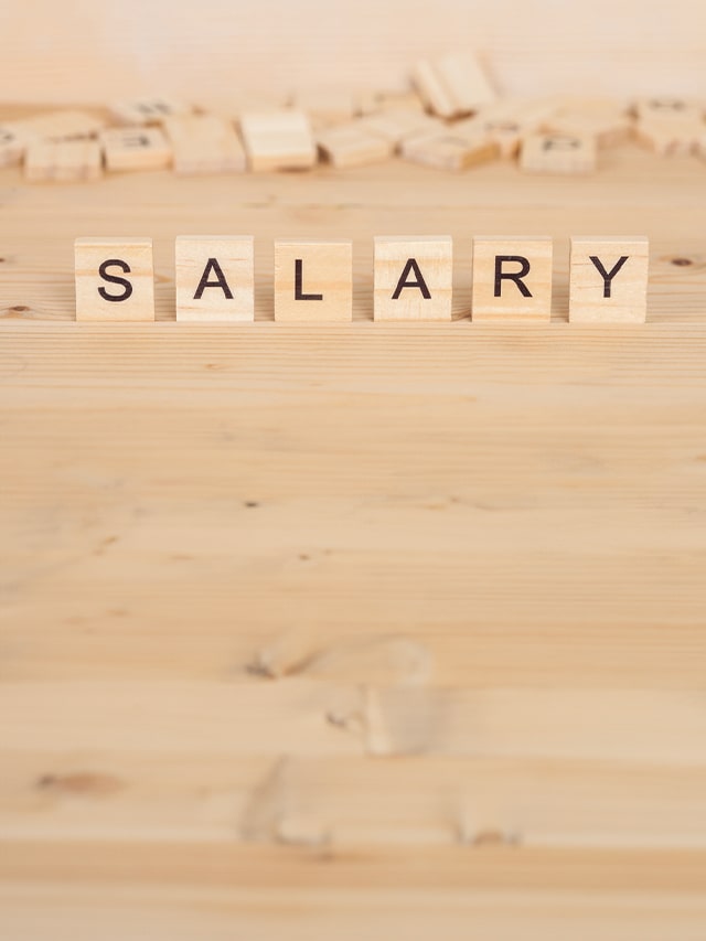 Salary word written on wood cube; concept of How to Negotiate Salary