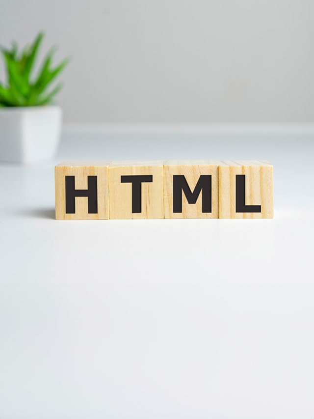 word HTML on wooden cubes, on white background; concept of Most Asked HTML Interview Questions in 2024