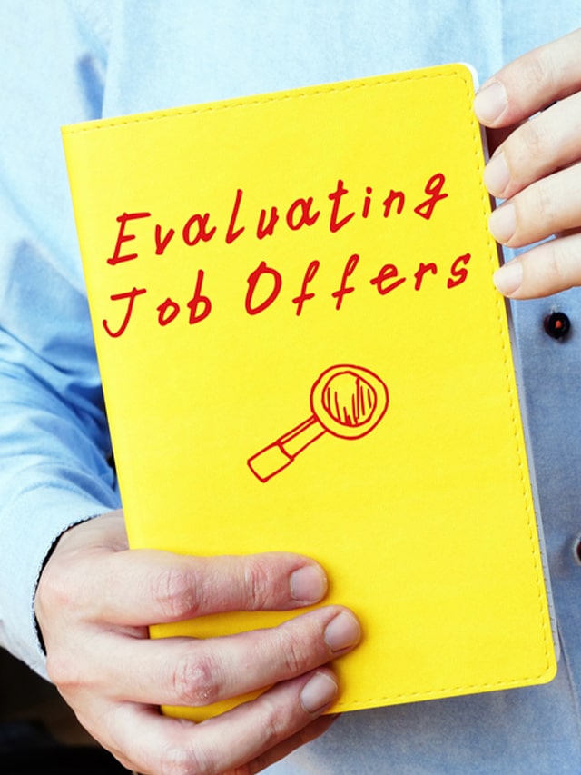 Business concept about Evaluating Job Offers with phrase on the piece of paper; concept of How to Evaluate a Job Offer